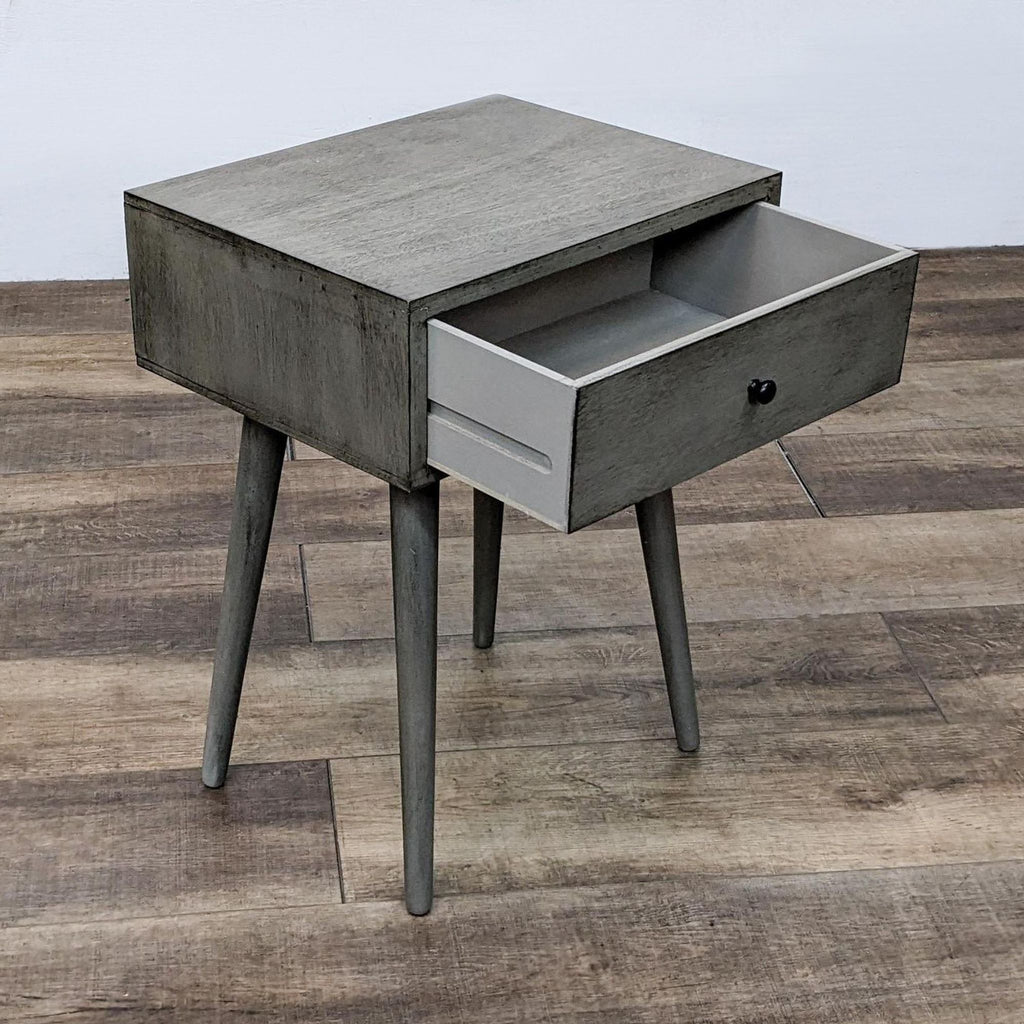 Grey end table from Reperch with open drawer revealing storage space.