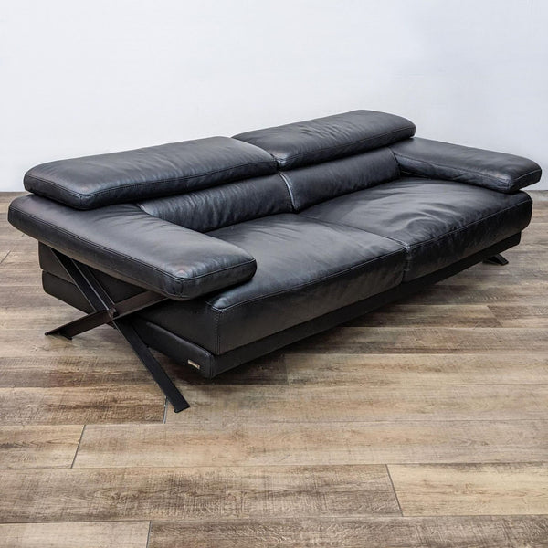 Black leather loveseat with metal side frame and adjustable headrests.
