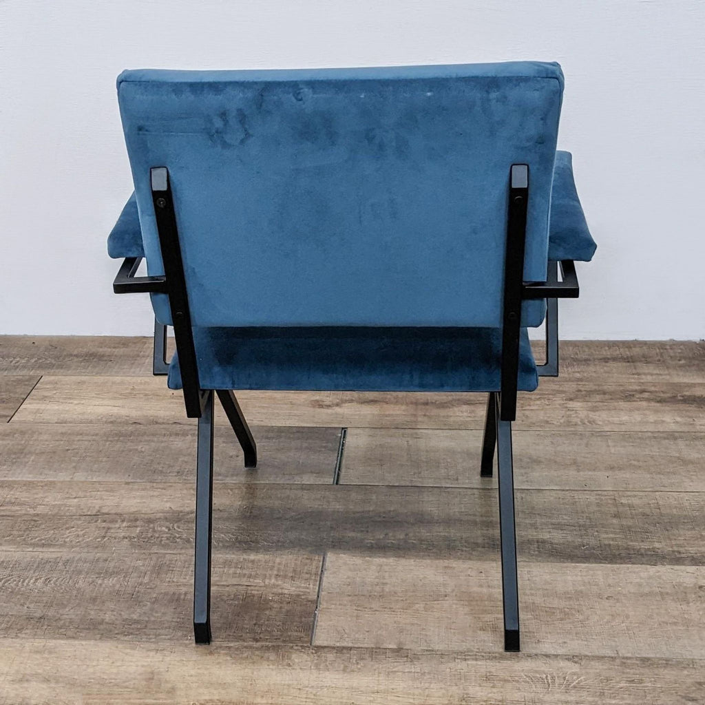 Back view of a contemporary dining chair with a soft microfiber seat and sturdy metal frame.