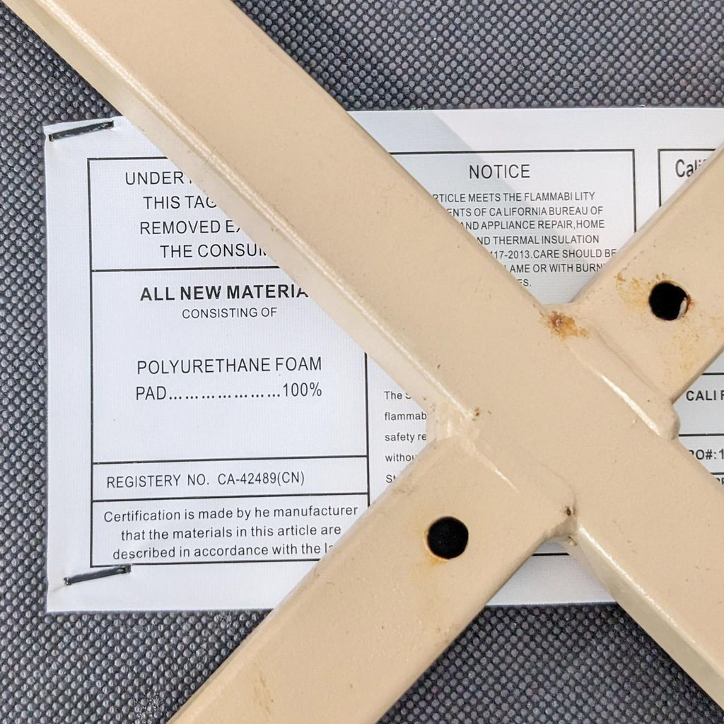 Underside tag of dining chair showing materials and specifications.