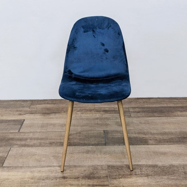 Mid-century modern velvet dining chair with tapered wood legs, front view.