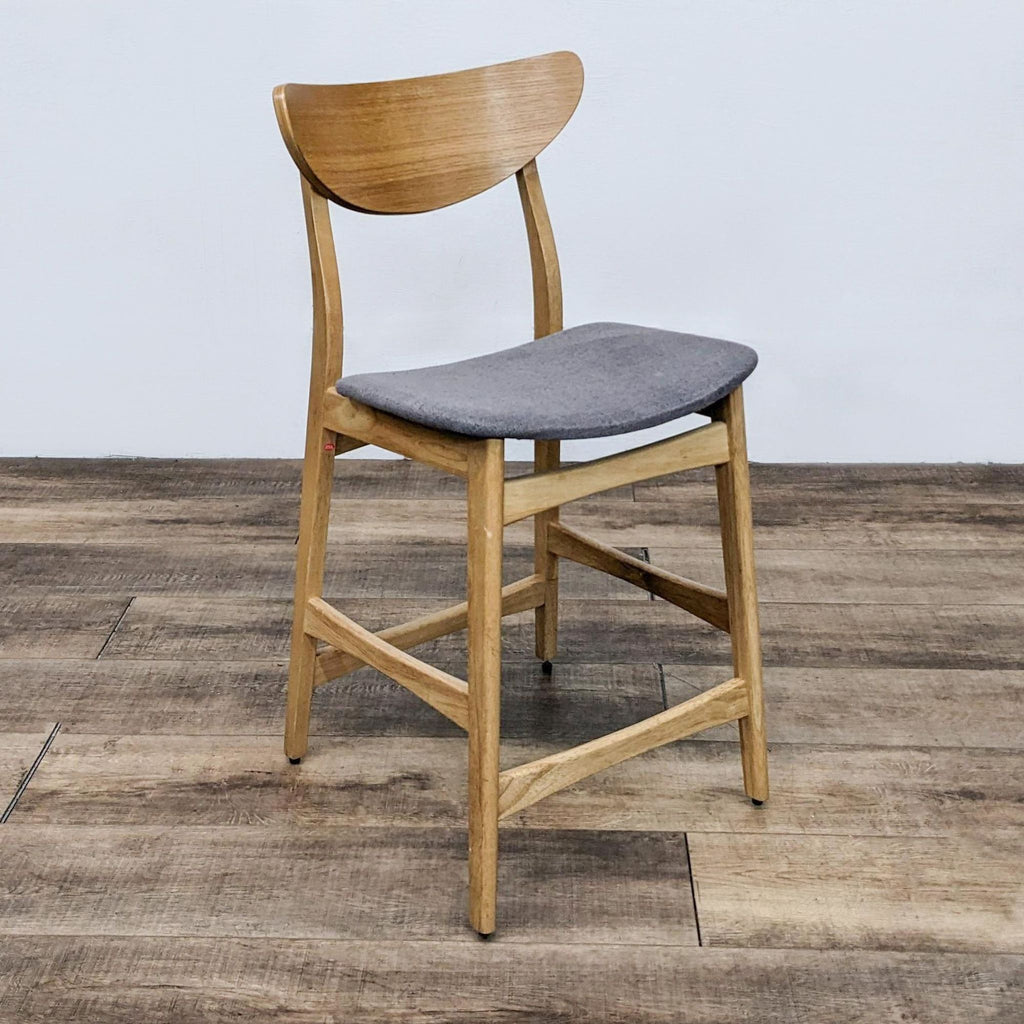 the chair is made of solid wood and has a gray cushion.