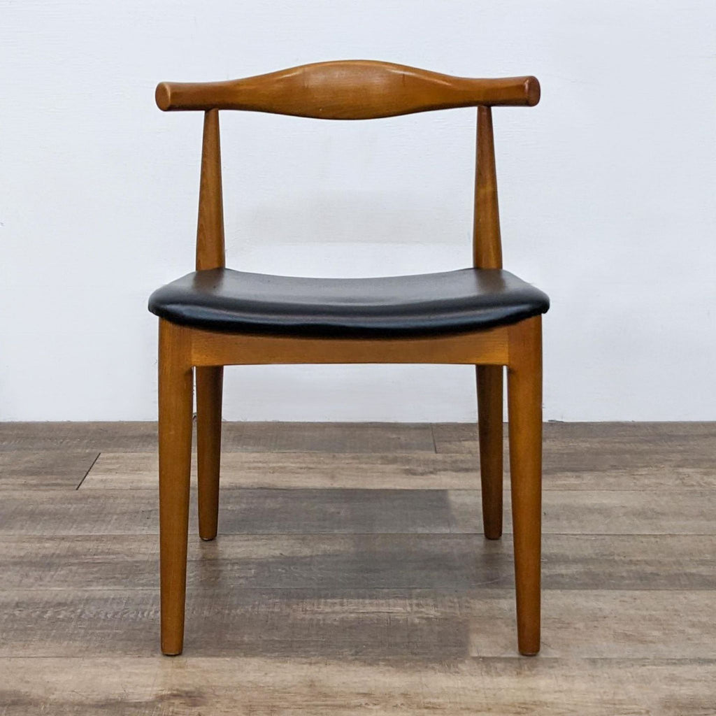 Danish style chair with curved wooden back and black leatherette seat.