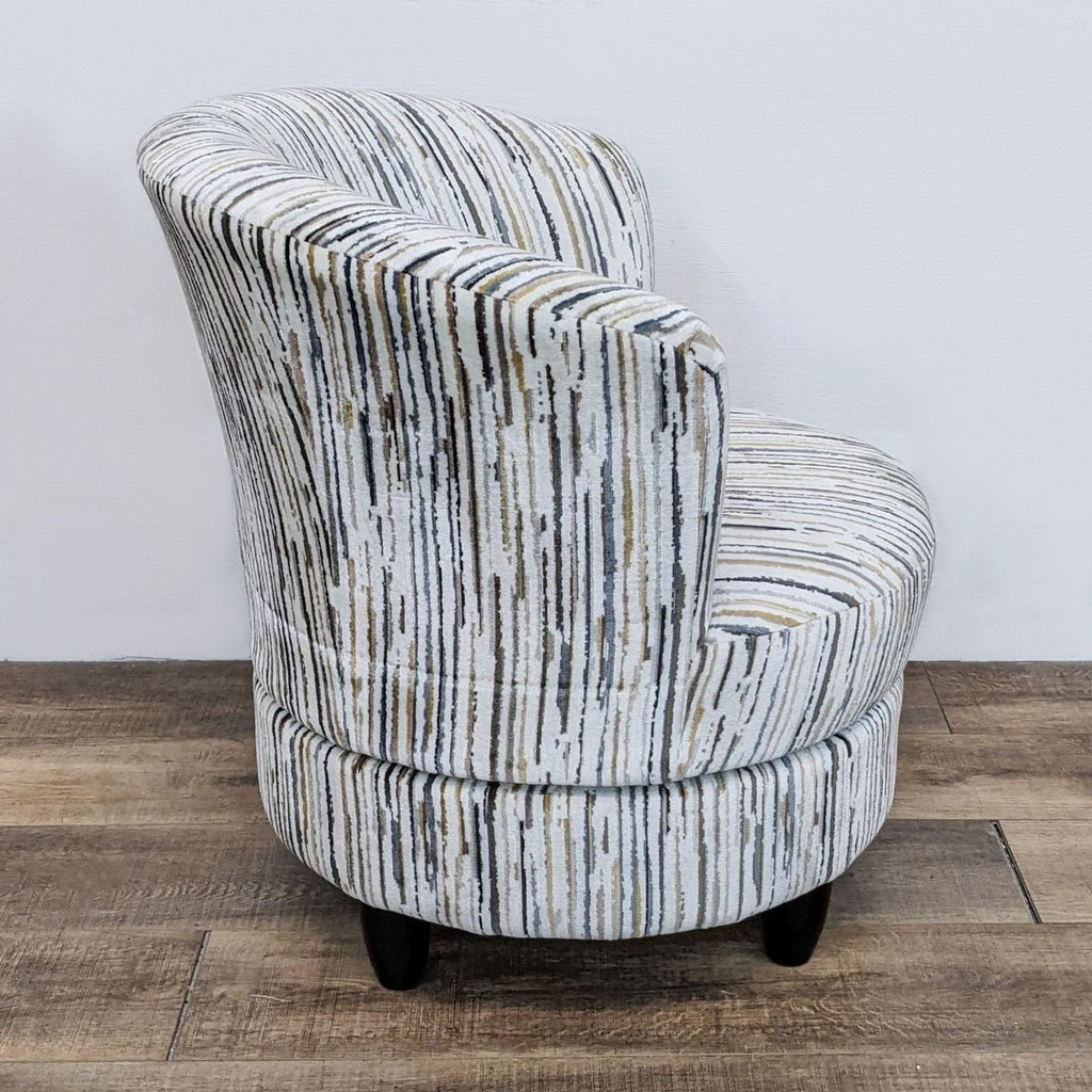 Side view of the Apollo chair by Living Spaces on a swivel base, showing its supportive design.