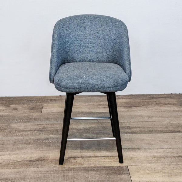 Curved swivel stool with dark wood frame and gray fabric.