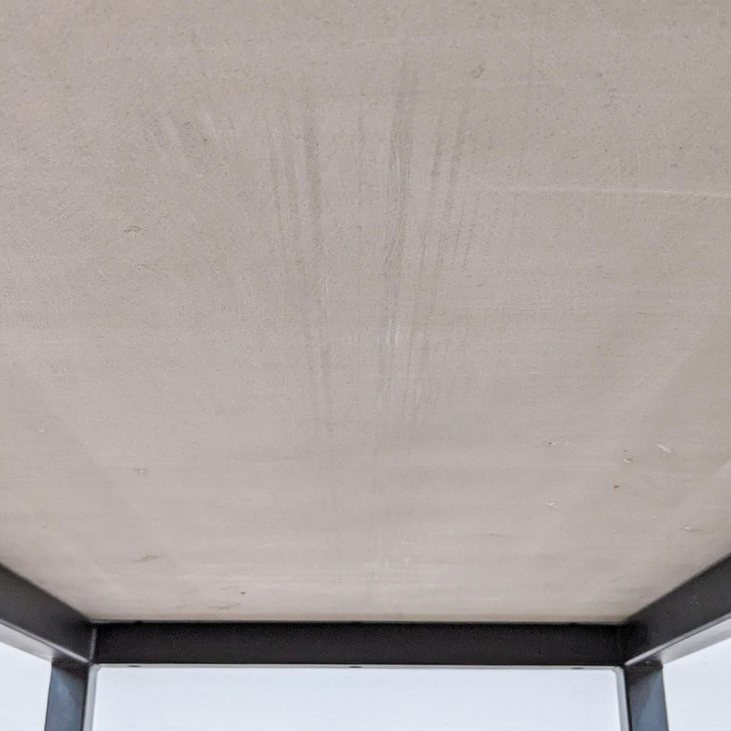 Close-up of the underside of a table with a smooth quartz surface.