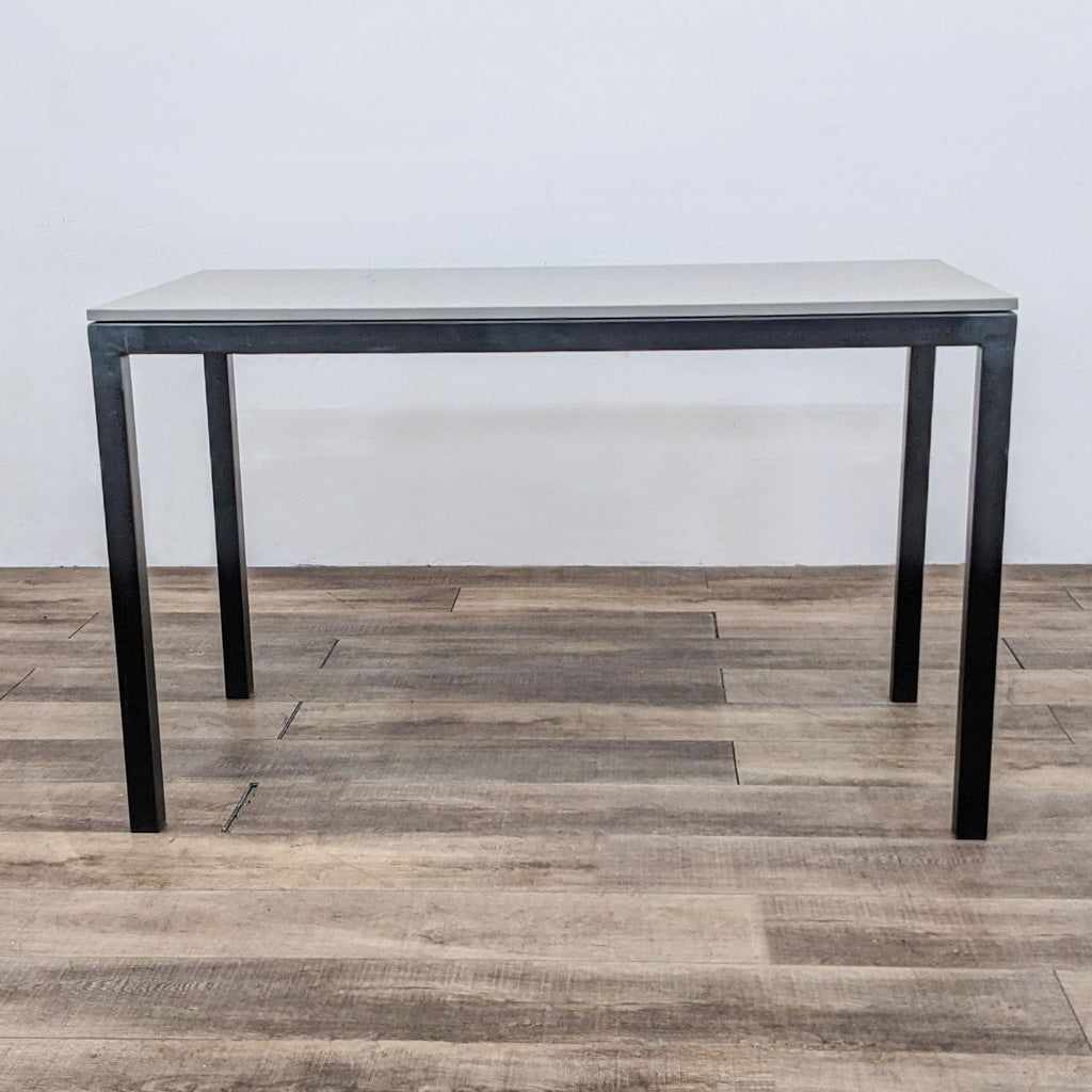 Modern dining table with welded steel base and quartz top.  