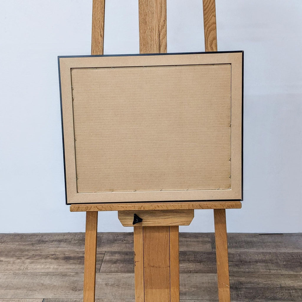Back view of a framed art print on an easel.