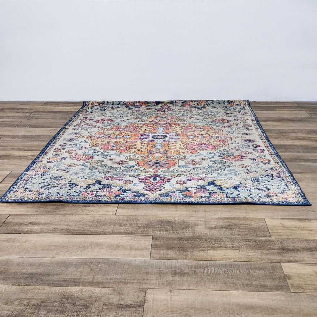 a large oriental rug with a blue and yellow floral pattern.
