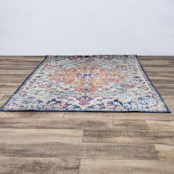a large oriental rug with a blue and yellow floral pattern.