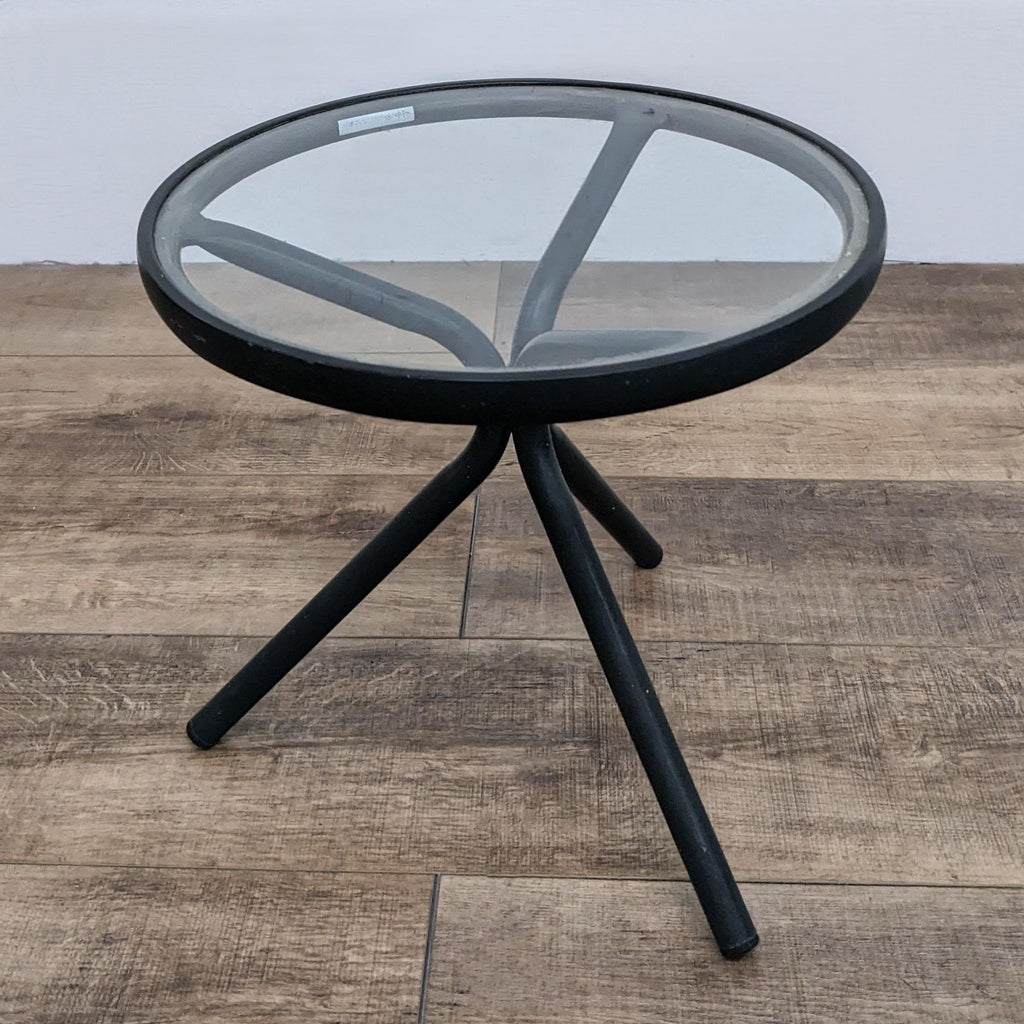 18" round accent table with glass surface and sleek metal frame.