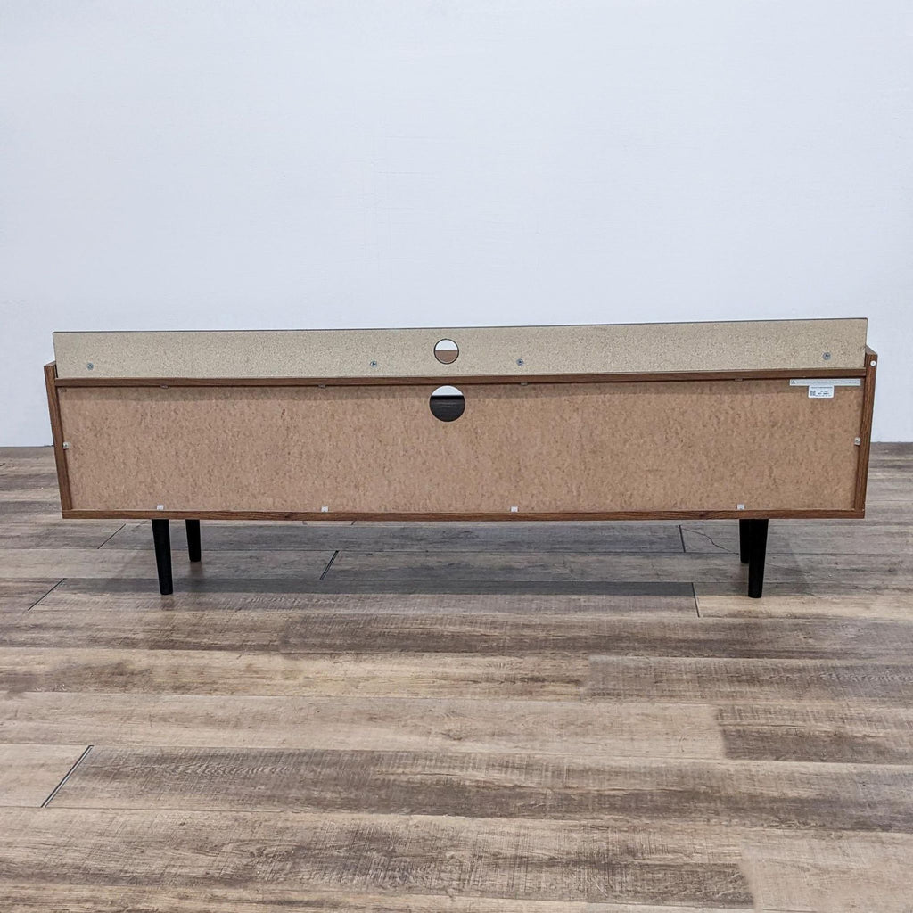 Back view of the Modway Visionary TV stand highlighting cable management holes.