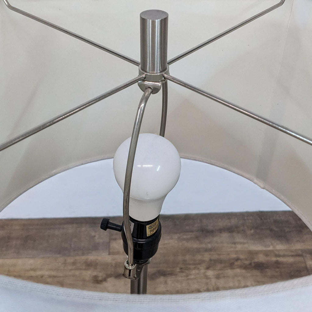 Close-up of a light bulb and interior structure of a Reperch lamp.