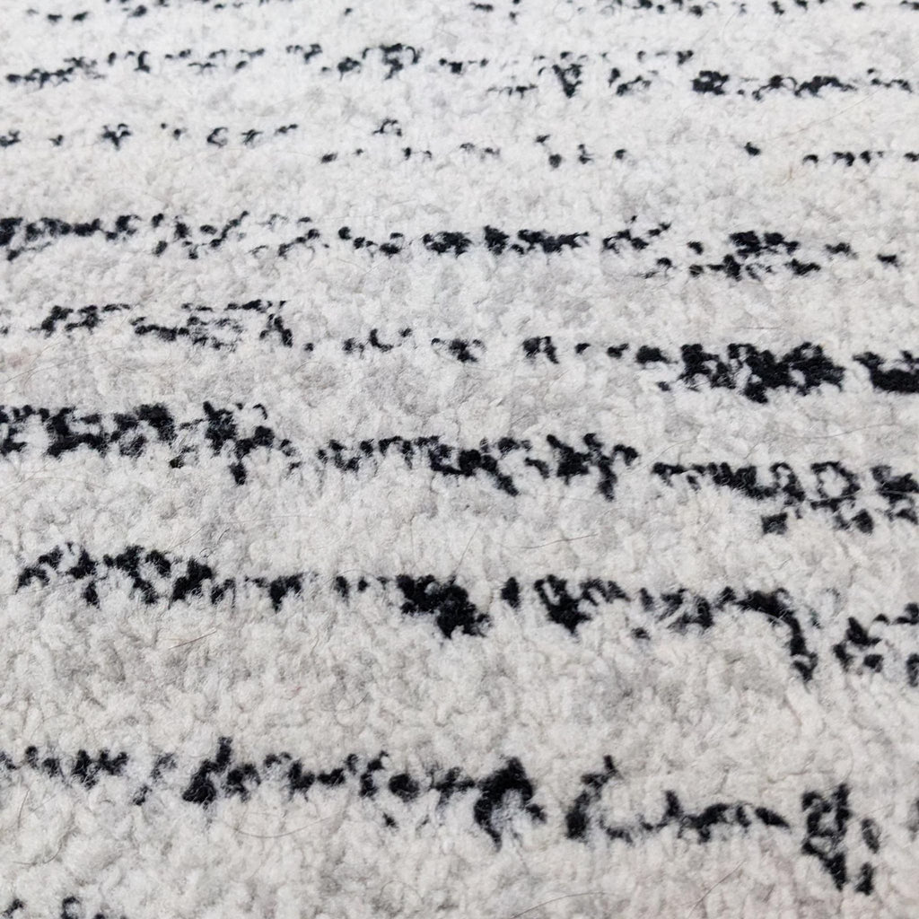 Close-up of the Safavieh ivory and silver rug's texture and pattern.