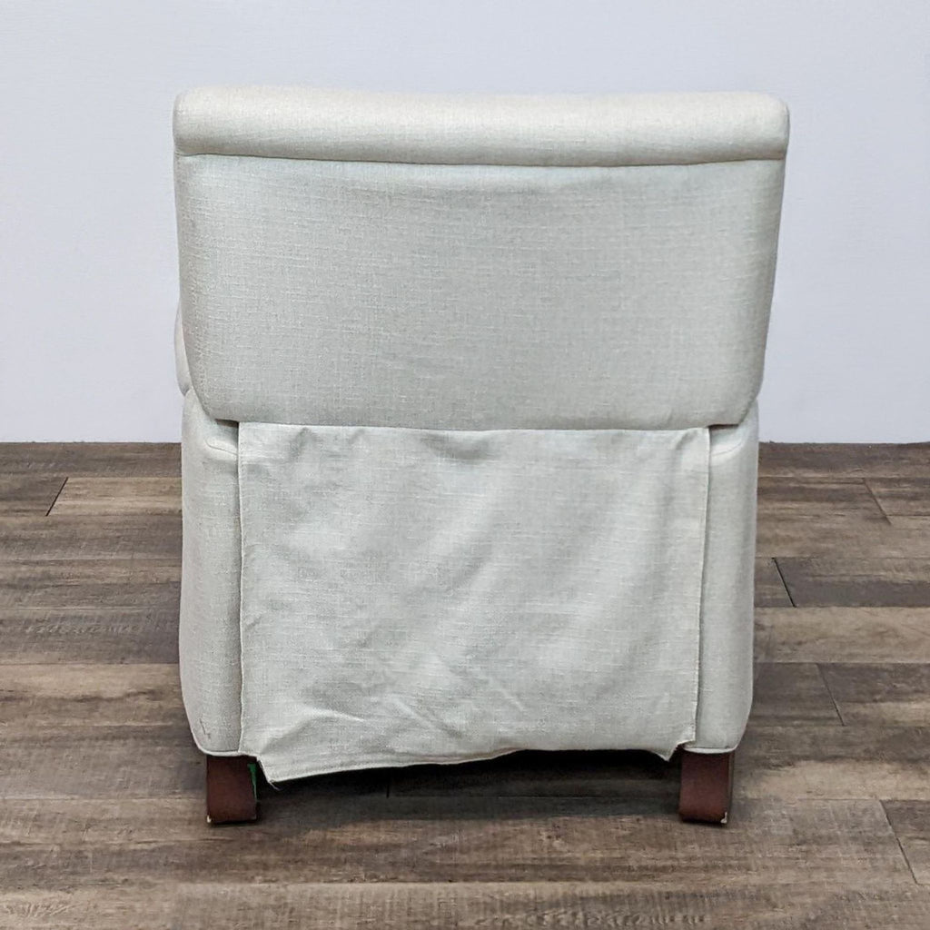 Back view of Pottery Barn Irving recliner in cream, highlighting sleek upholstery and woodblock feet.