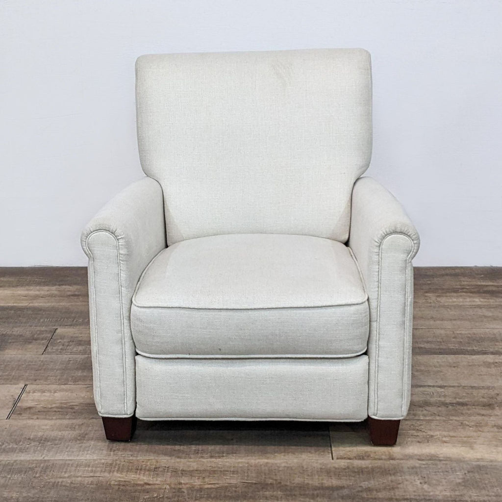 Front view of Pottery Barn Irving recliner in cream, showing roll arms and woodblock feet.