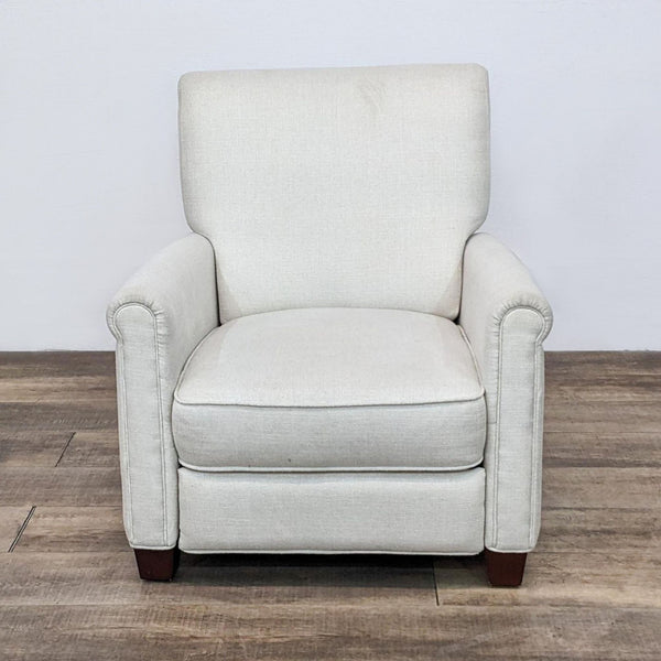 Front view of Pottery Barn Irving recliner in cream, showing roll arms and woodblock feet.