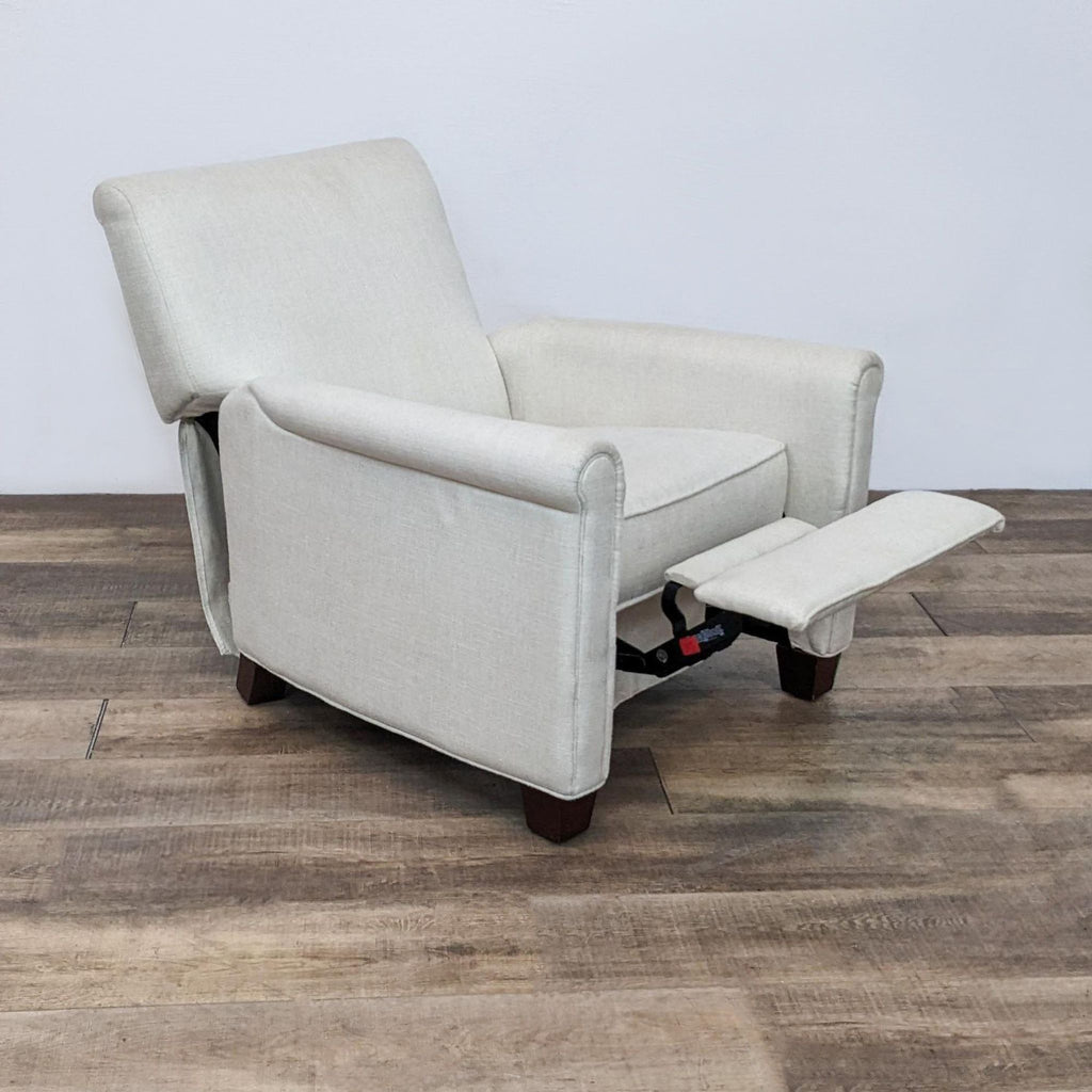 Side view of Pottery Barn Irving recliner with extended footrest and classic club chair style.