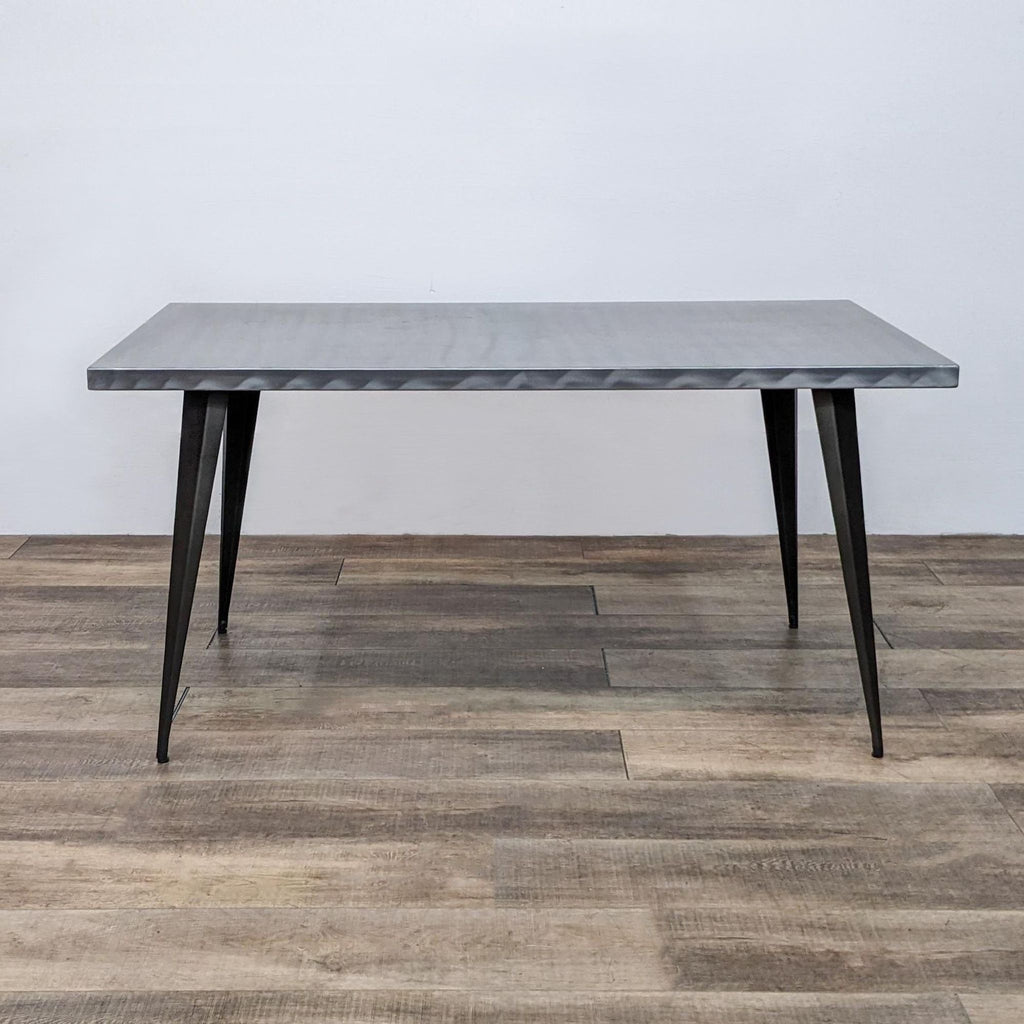 Industrial-style dining table with metal construction and tapered legs by Lumisource.