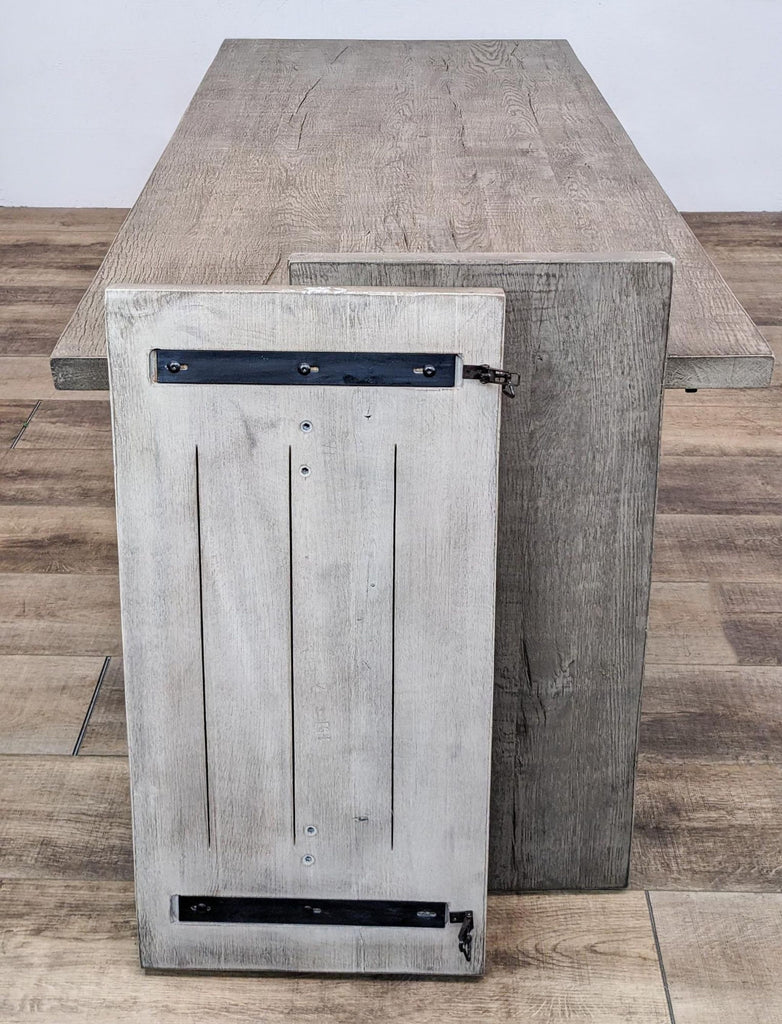 Close-up of the oak table's breadboard extension with grip screws.