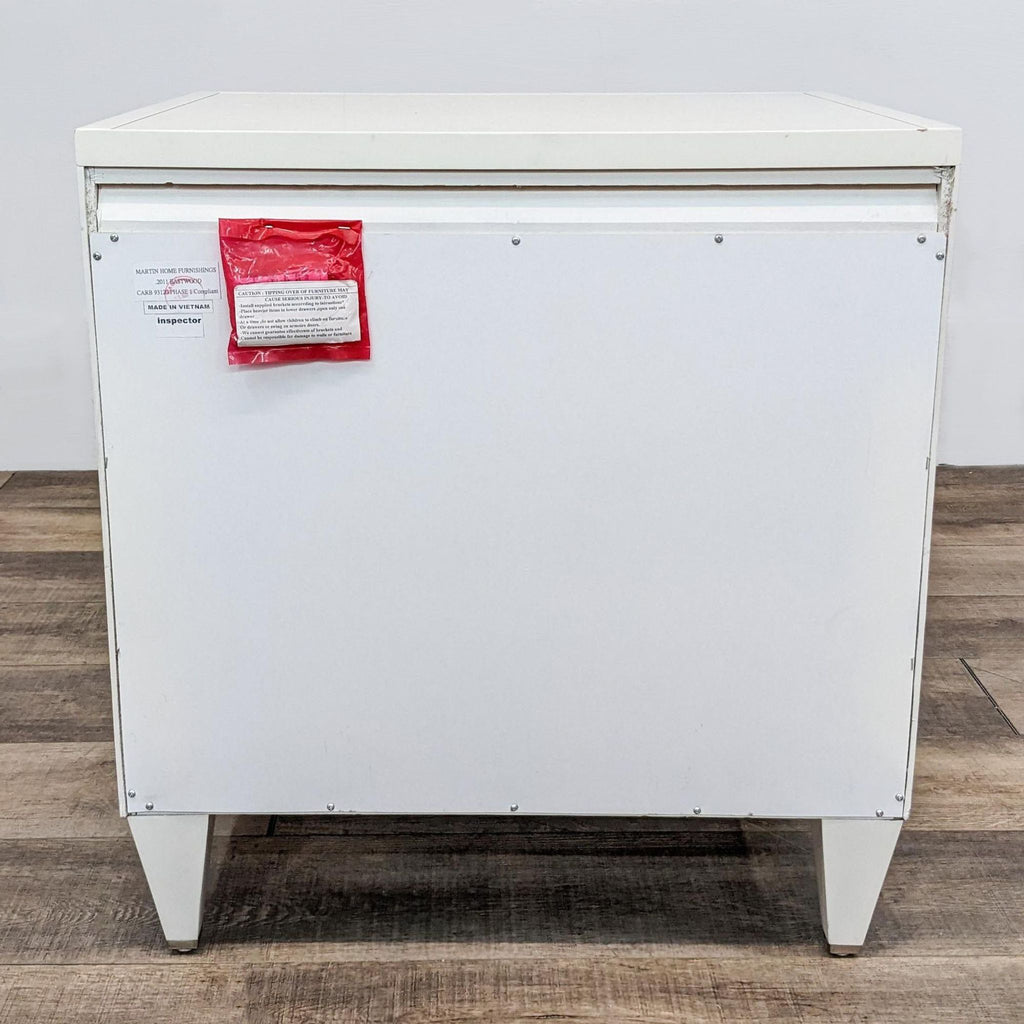 Back view of an end table with a white finish and attached red inspection tag.
