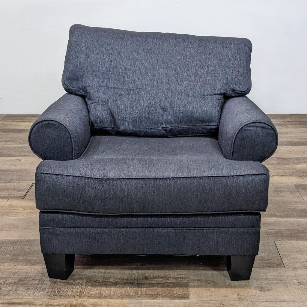 Front view of a grey lounge chair by Reperch with rolled arms and wood feet.