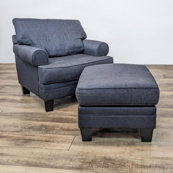 Reperch lounge chair with rolled arms and matching ottoman on wood floor.