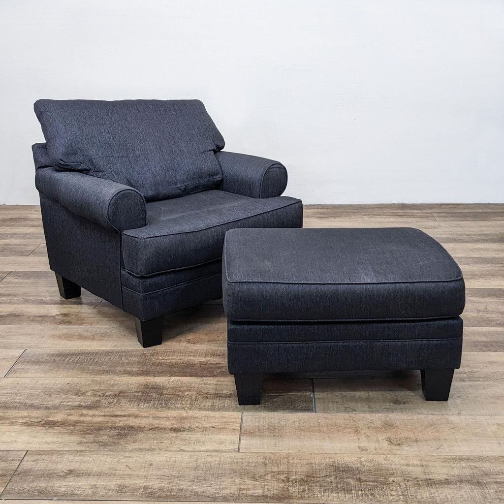 Contemporary grey lounge chair with ottoman, featuring T-style cushions and tapered feet.