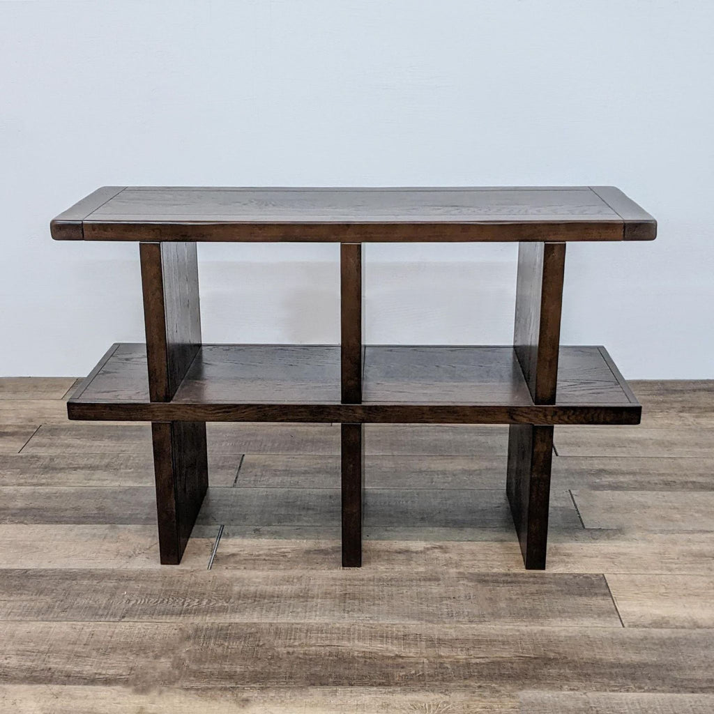 Dark wood console table with two shelves and a modern design, by Pottery Barn.