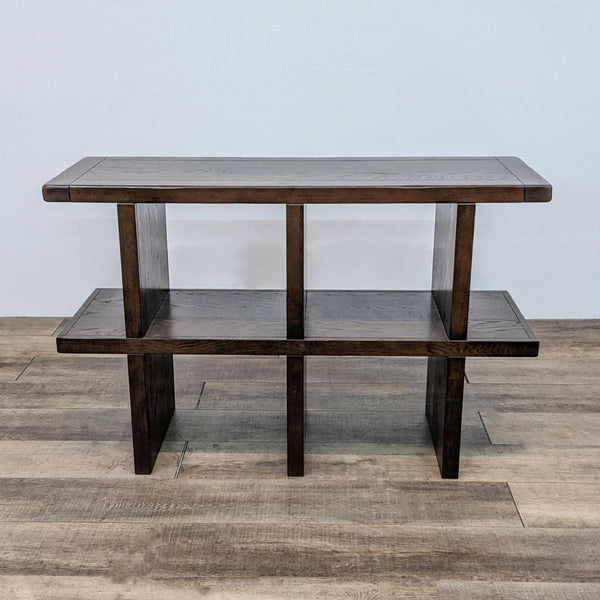 Dark wood console table with two shelves and a modern design, by Pottery Barn.
