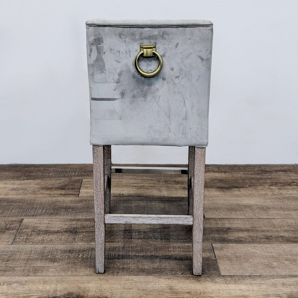 Back view of stool with brass ring detail.