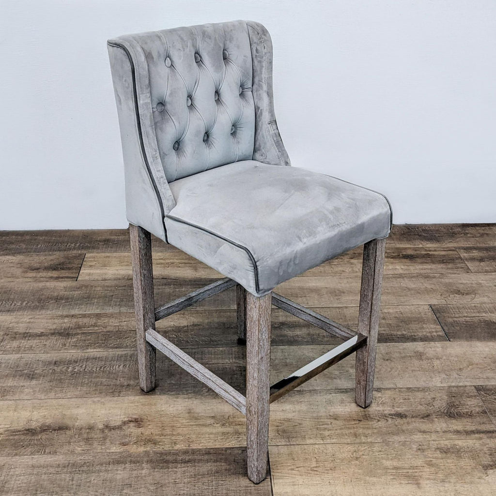 Tufted stool with solid wood frame and leather piping.