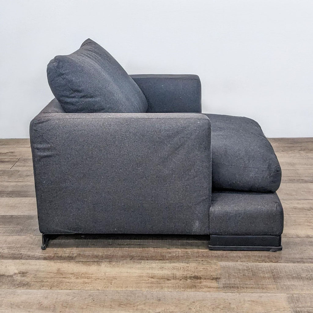 Side view of the Easytime Chair showing its sculpted silhouette and supportive cushions.