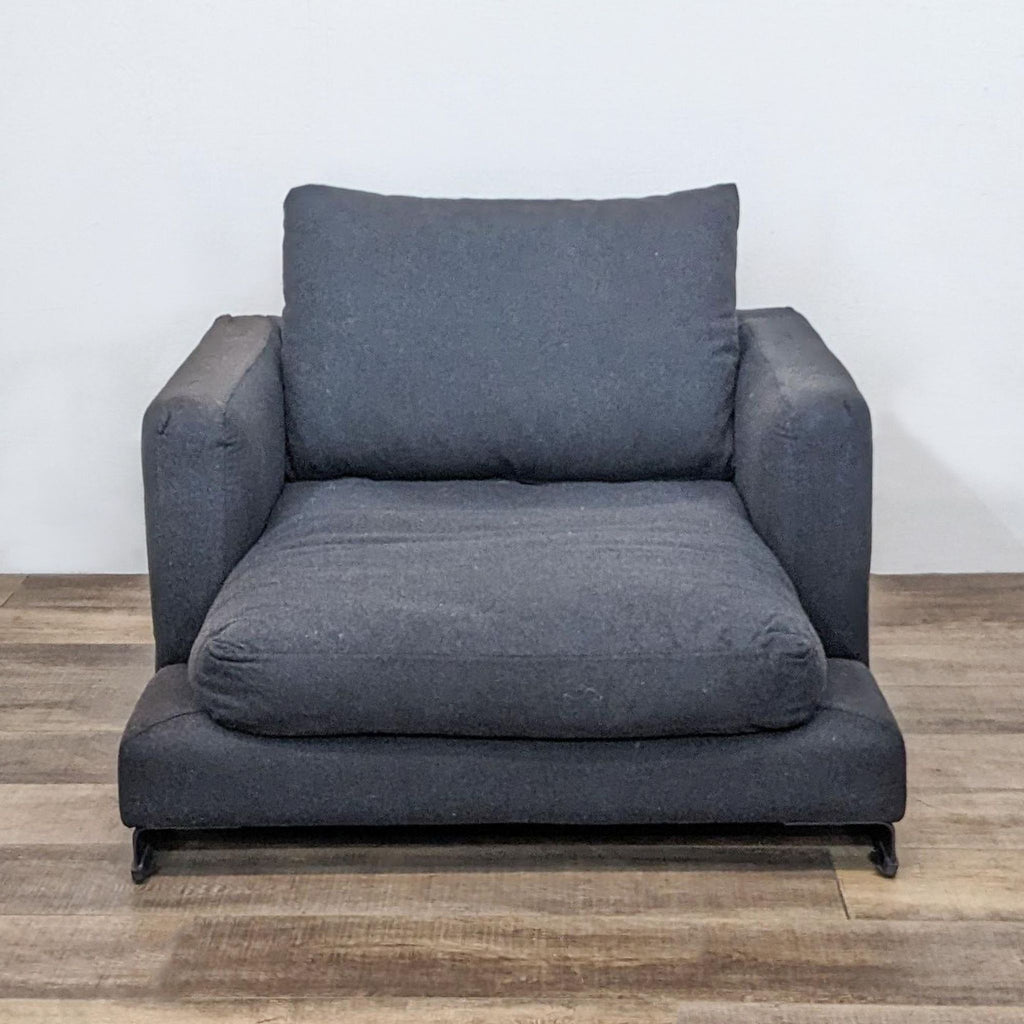 Front view of the Easytime Chair with plush cushions and steel legs.