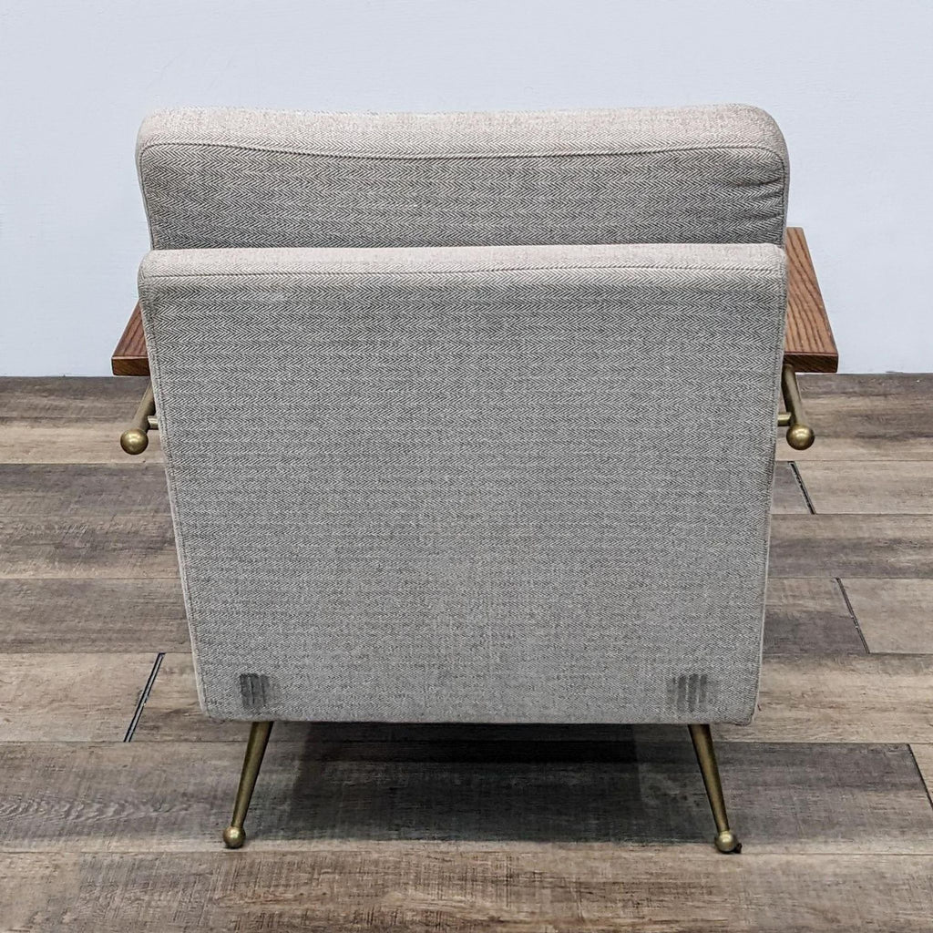 Back angle of a sleek modern chair with wooden armrests by MXM.