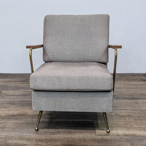 Front view of a modern lounge chair with brass frame and walnut arms.