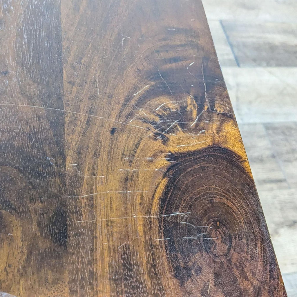 Close-up of the wood grain and texture on a dark wood table, showing natural patterns.