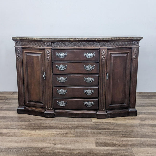Elegant wooden sideboard with fluted columns, ornate pewter handles, and a serpentine top.