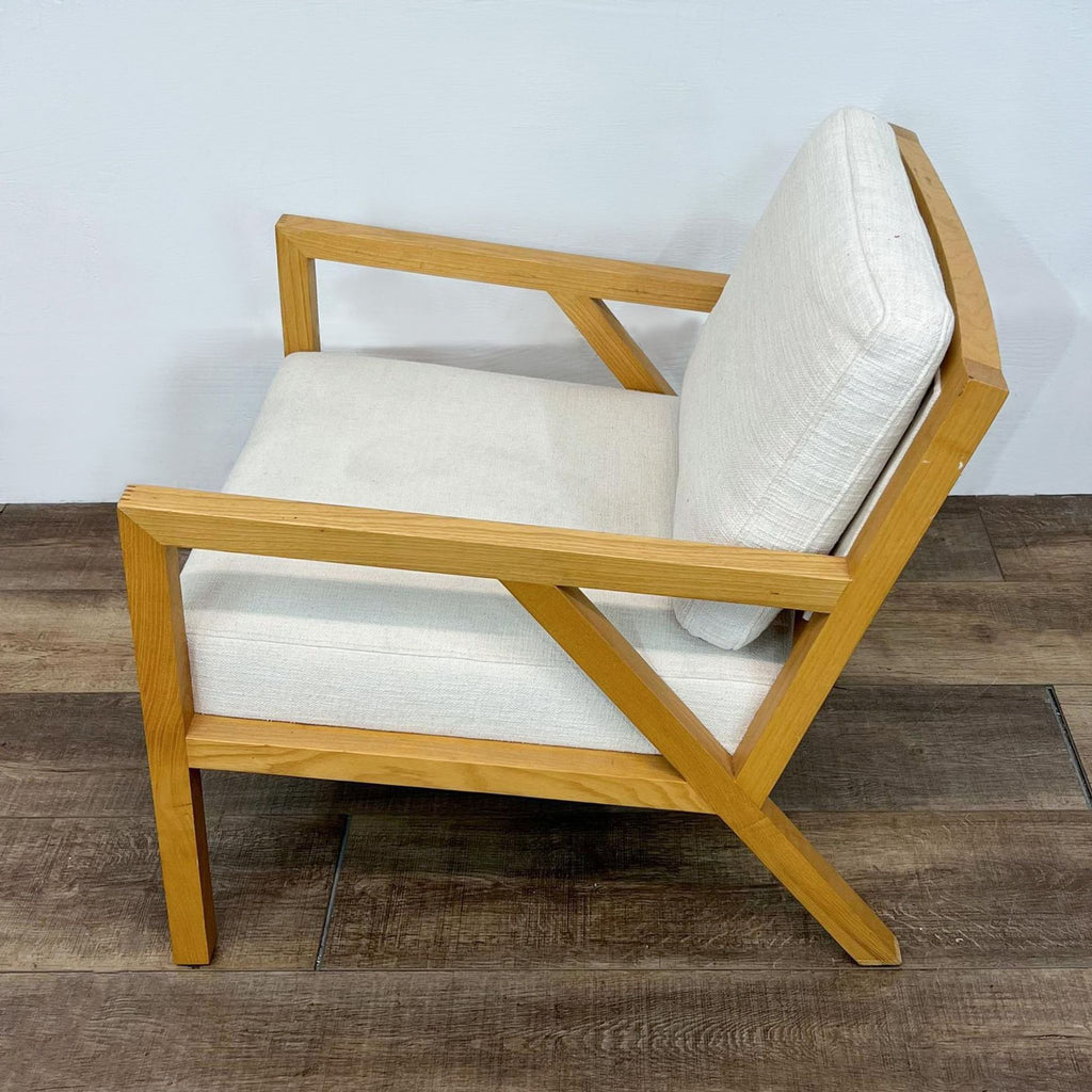 Side view of mid-century chair with natural wood and removable cushions.