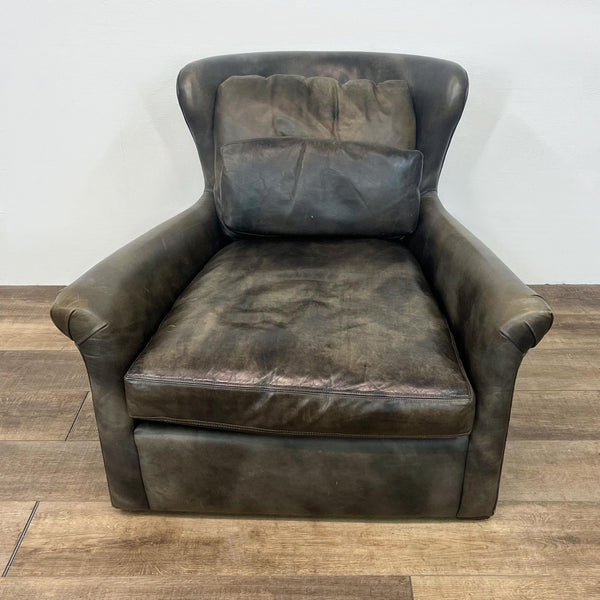 Leather swivel lounge chair with rolled arms and hidden base.  