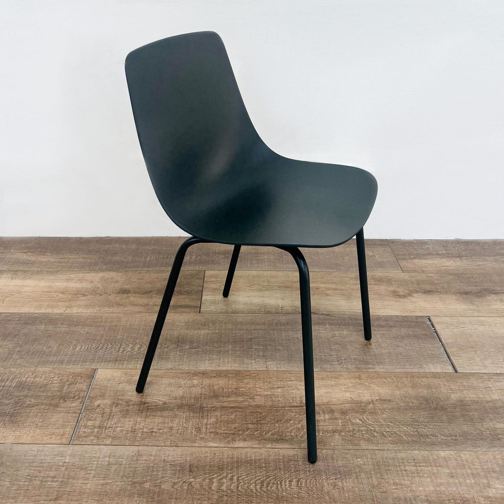 Side view of the Clean Cut chair by Blu Dot, featuring a contoured plywood seat and steel base.