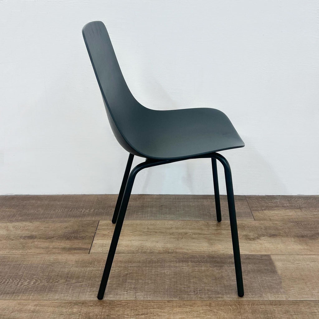 The Clean Cut dining chair by Blu Dot, showcasing its modern design with bent steel and painted plywood.