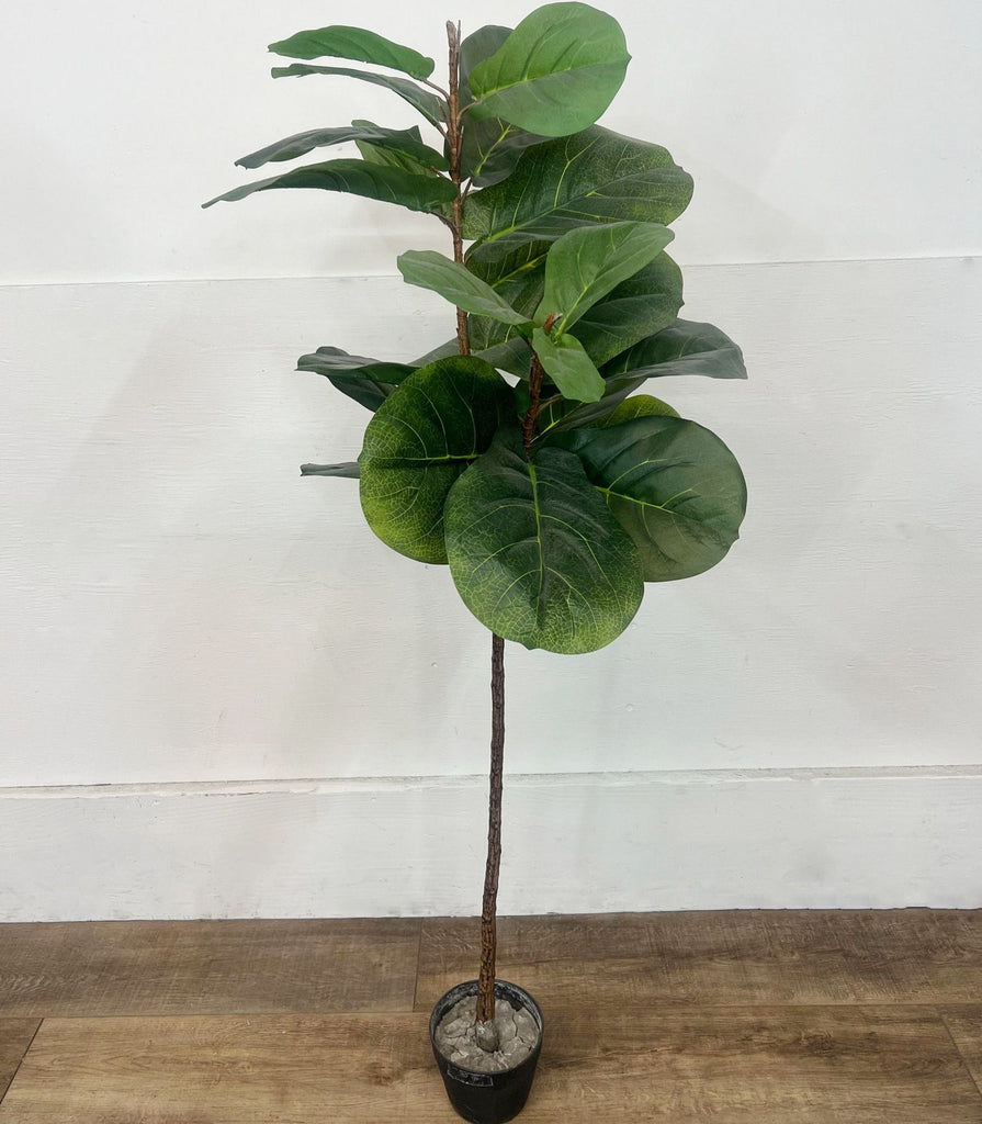 Tall artificial fiddle leaf fig tree in a black pot, showcasing broad, vibrant green leaves.