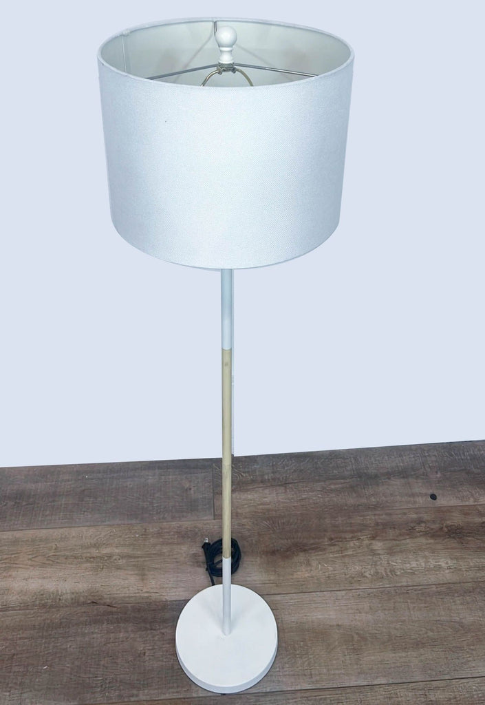 a vintage floor lamp with a white shade.