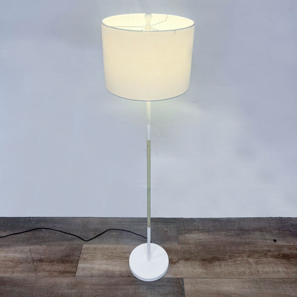 the lamp is made of metal and has a white plastic shade.