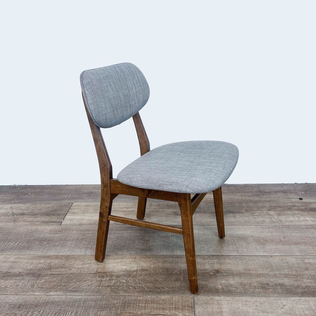 Angle view of Midtown dining chair by Zuo Modern, featuring modern design and gray upholstery.