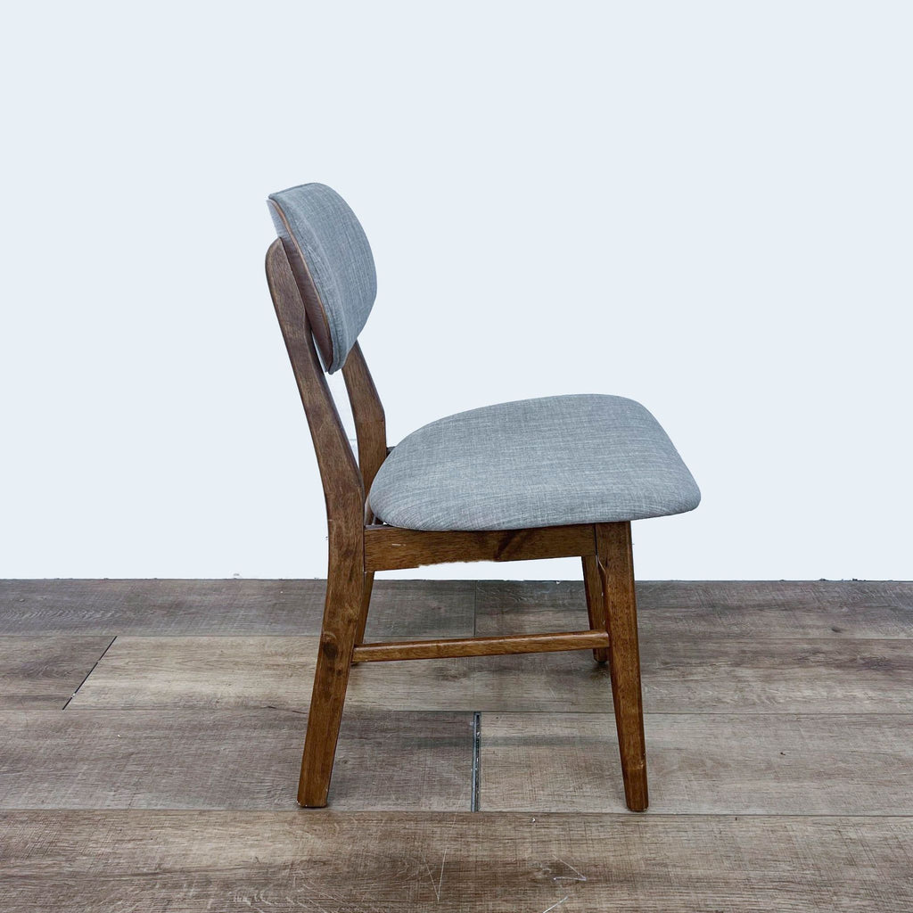 Side view of modern Midtown dining chair by Zuo Modern, wood and gray fabric.
