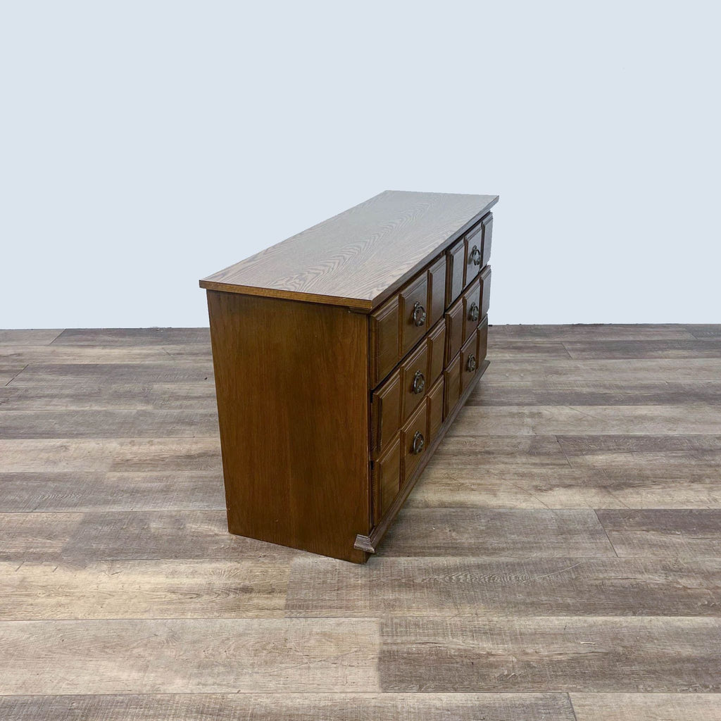 Side view of vintage Reperch dresser with raised panel drawers, showcasing its wooden panel detail.