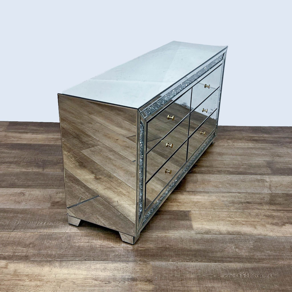Side angle of mirrored dresser, highlighting its modern design and gold accents.