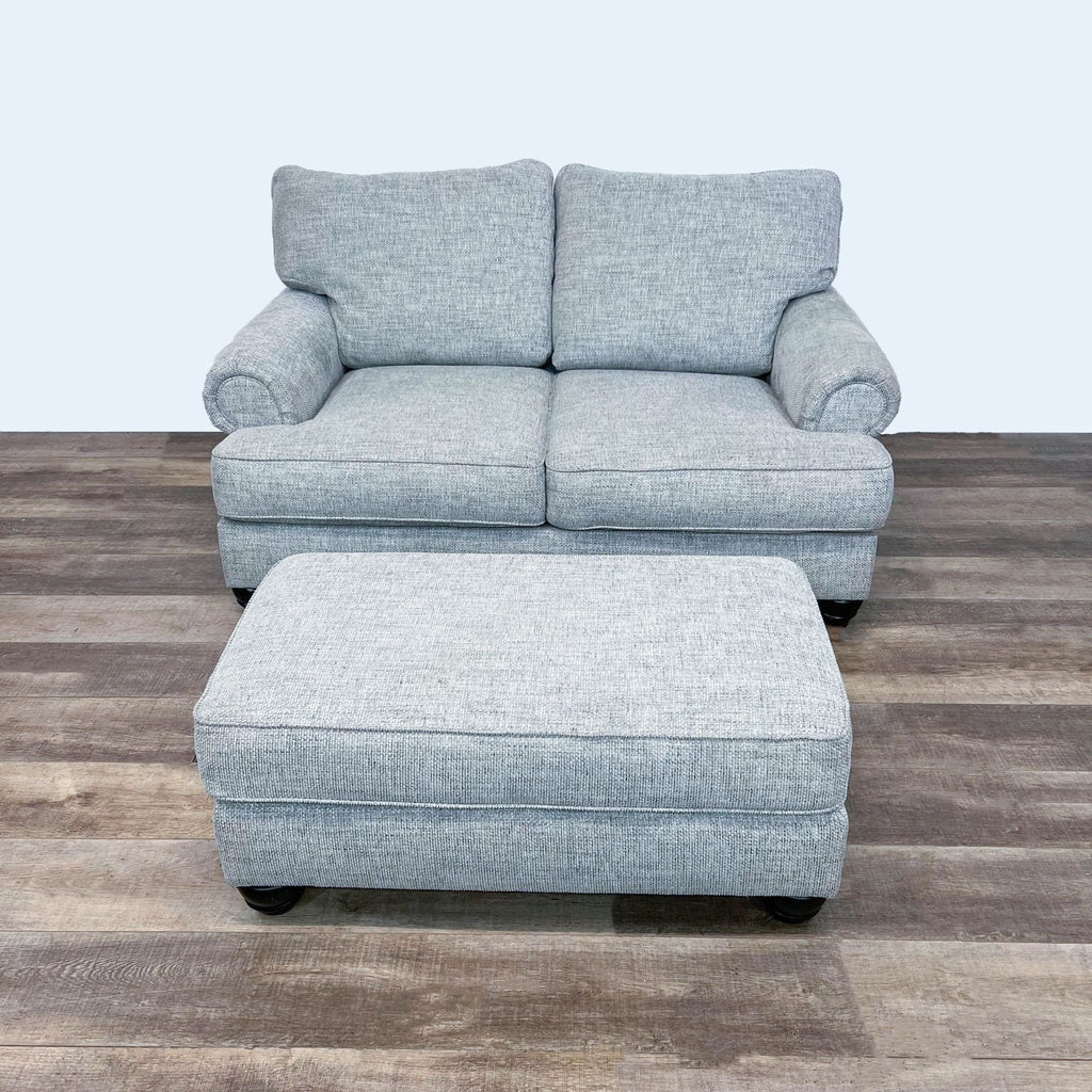 1. Reperch loveseat and rectangular ottoman in matching fabric with dark bun feet, shown on wood floor.  